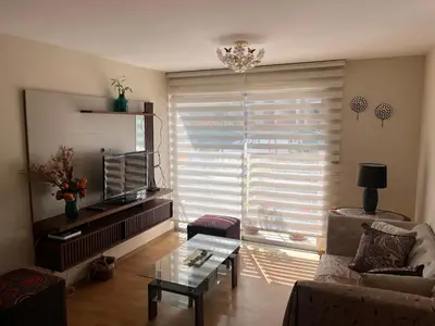 a living room with a couch and a window with blinds at Céntrico y funcional apartamento 2 dormitorios JESÚS MARÍA LIMA in Lima