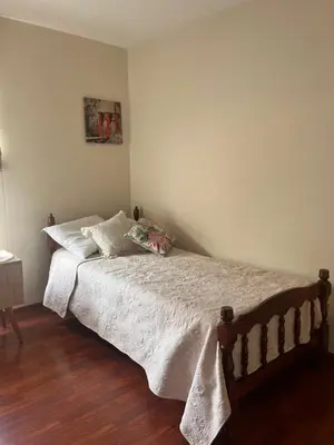 a bedroom with a bed with a wooden floor at Céntrico y funcional apartamento 2 dormitorios JESÚS MARÍA LIMA in Lima