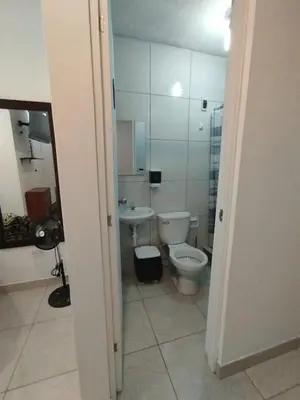 a bathroom with a toilet and a sink at Comfortable House in Punta Hermosa