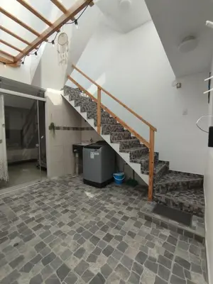 a staircase in a room with a tiled floor at Comfortable House in Punta Hermosa
