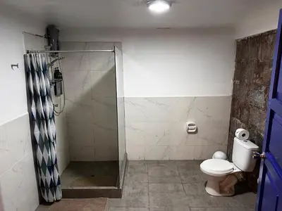 a bathroom with a shower and a toilet at yuraqtampu- Pardo in Cusco