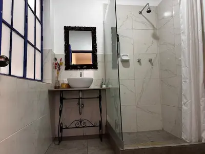 a bathroom with a sink and a shower at yuraqtampu- Pardo in Cusco
