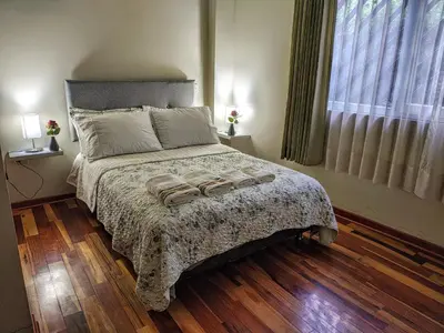 a bedroom with a bed with two towels on it at Zisary's House Apartment in Cusco