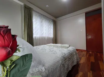a bedroom with a bed with two towels on it at Zisary's House Apartment in Cusco