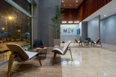 a lobby with chairs and tables in a building at Met Moderno Departamento in Lima