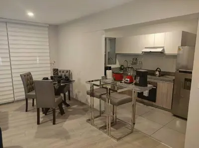 a kitchen with a table and chairs in a room at Met Moderno Departamento in Lima