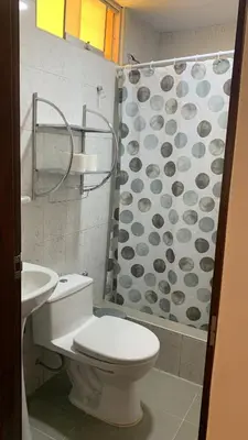 a bathroom with a toilet and a shower at Lindo depa san miguel, 3camas, wifi, terraza. in Lima