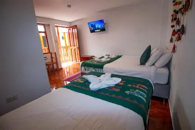 a room with two beds with towels on them at Munay Ñusta Cusco in Cusco