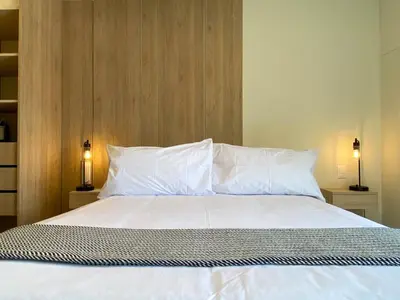 a bedroom with a bed with white sheets and pillows at Pod by Wynwood House in Lima