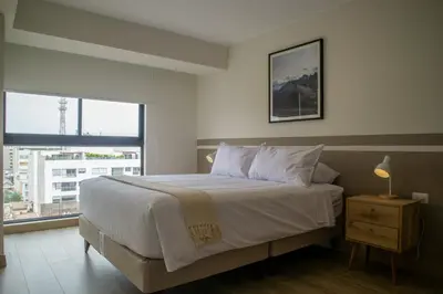 a bedroom with a large bed and a window at Pod by Wynwood House in Lima