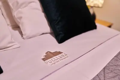 a bed with a pillow on top of it at Pucllana BBBoutique in Lima