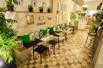 a restaurant with tables and chairs and plants at Pucllana BBBoutique in Lima