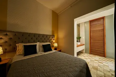 a bedroom with a large bed with a large headboard at Pucllana BBBoutique in Lima