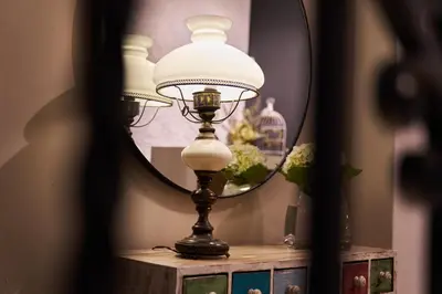 a lamp sitting on a table in front of a mirror at Pucllana BBBoutique in Lima
