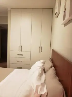 a bedroom with a bed with white cabinets at Central, petfriendly family apartment in Lima
