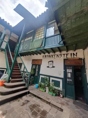 a building with a stairway in front of a building at Royal Frankenstein Hostel in Cusco