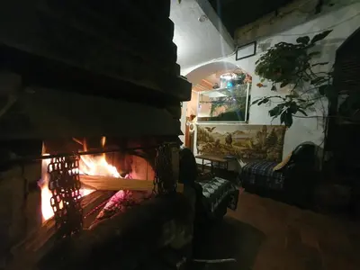 a fireplace in a living room with a fire place at Royal Frankenstein Hostel in Cusco