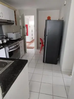 a kitchen with a black refrigerator in a room at Comfortapartment in Lima