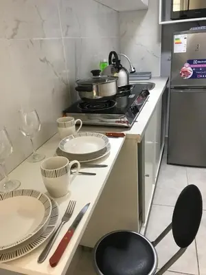a kitchen with plates and utensils on a counter at Albano habitación acústica cocina y baño in Chosica