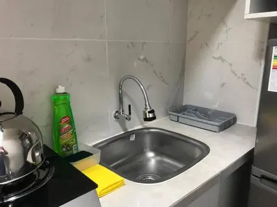 a kitchen counter with a stainless steel sink at Albano habitación acústica cocina y baño in Chosica
