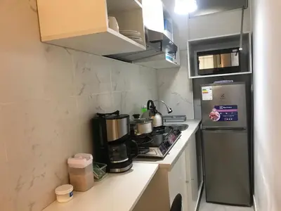 a small kitchen with a stove and a refrigerator at Albano habitación acústica cocina y baño in Chosica