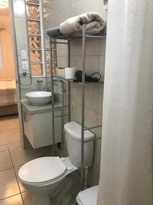 a bathroom with a toilet and a sink at Albano habitación acústica cocina y baño in Chosica