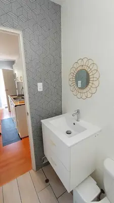 a bathroom with a sink and a mirror on a wall at Live, Work & Comfort San Isidro in Lima