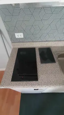 a kitchen counter with a stove and a sink at Live, Work & Comfort San Isidro in Lima