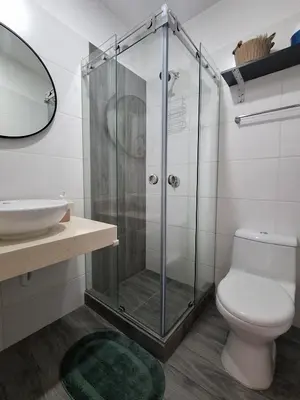 a bathroom with a shower and a toilet and a sink at Apartamento con increíble vista al mar in Lima