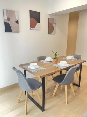 a dining room table with four chairs and a table at Departamento de Estreno en Miraflores in Lima