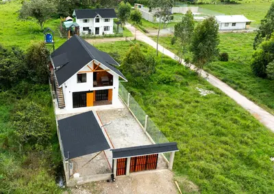 an overhead view of a small house in a field at La casa de Anni - Departamento 1 in Oxapampa