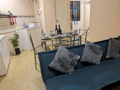 a living room with a blue couch and a table at Apartamento privado, comodo y amplio, cerca al Centro de Lima in Lima