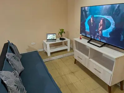 a living room with a large flat screen tv at Apartamento privado, comodo y amplio, cerca al Centro de Lima in Lima