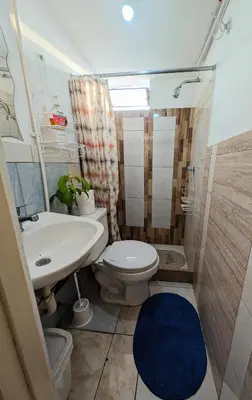 a small bathroom with a toilet and a sink at Apartamento privado, comodo y amplio, cerca al Centro de Lima in Lima