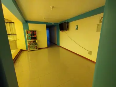 a hallway of a hospital with a tv on the wall at hotel plaza chinchero in Cusco