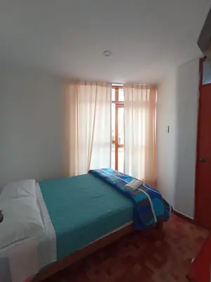a bedroom with a large bed with a window at El Capricho II Paracas in Paracas