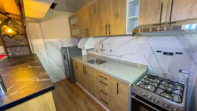 a small kitchen with a sink and a stove at Apart Hotel de Alegria in Cusco