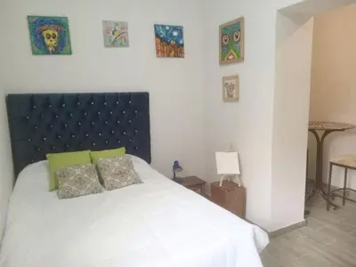 a bedroom with a white bed with two pillows at Colores Hospedaje Miraflores in Lima