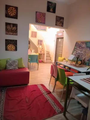 a living room with colorful chairs and a table at Colores Hospedaje Miraflores in Lima