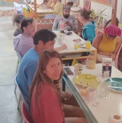 a group of people sitting at tables in a restaurant at Colores Hospedaje Miraflores in Lima