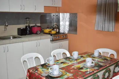 a kitchen with a table with chairs and a counter top at Saga Andina II in Cusco