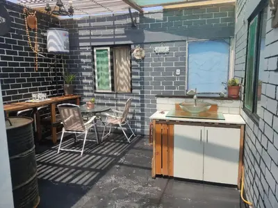a patio with a sink and a table and chairs at Beach House SantaElena in Pisco