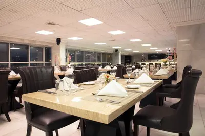 a dining room with a long table and chairs at Luxury Inkari Hotel in Lima