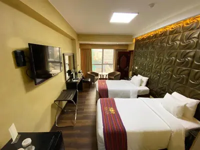 a hotel room with two beds and a flat screen tv at Luxury Inkari Hotel in Lima