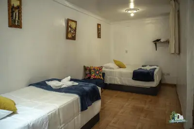 a room with two beds in a room at BEAUTIFUL, SPACIOUS & COZY HOUSE LOCATED IN THE HEART OF CUSCO in Cusco