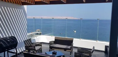 a balcony with chairs and a view of the ocean at Nuevo Paracas Apartment in Paracas