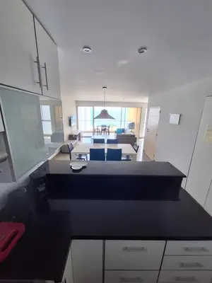 a view of a kitchen and a living room at Nuevo Paracas Apartment in Paracas