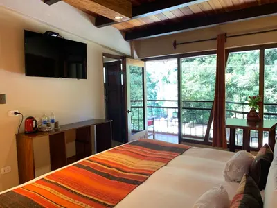 a bedroom with a large bed and a large window at Panorama B&B in Machu Picchu