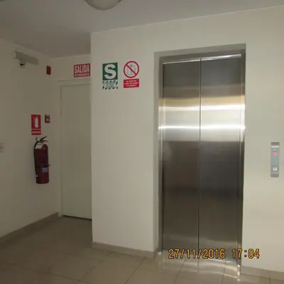 an elevator in a building with signs on the wall at Bonito Apartamento en Miraflores in Lima