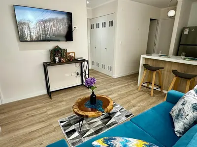a living room with a blue couch and a table at Cozy Apartment in Barranco! in Lima